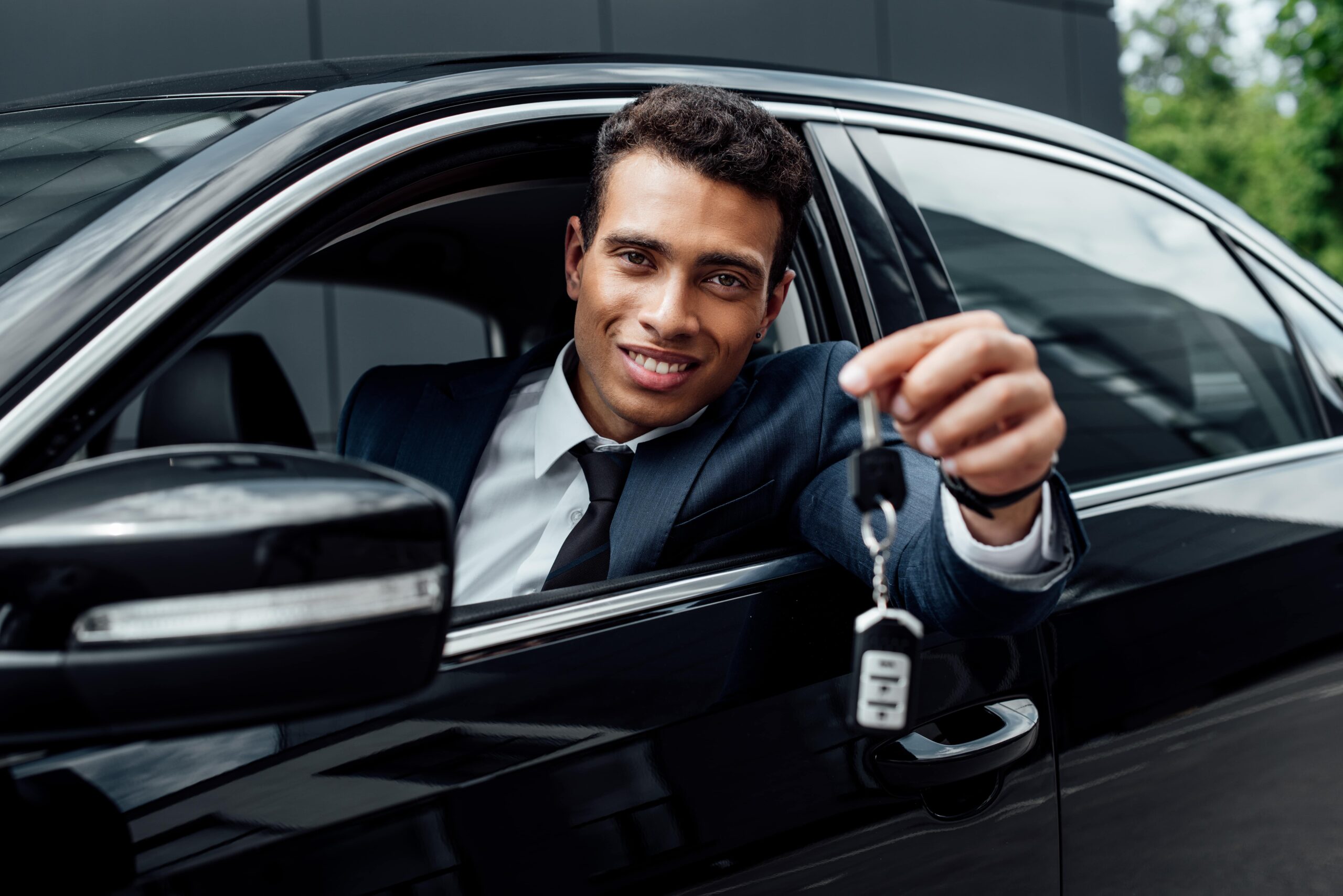 happy-african-american-businessman-holding-car-key-2022-12-16-16-36-17-utc-min-scaled.jpg